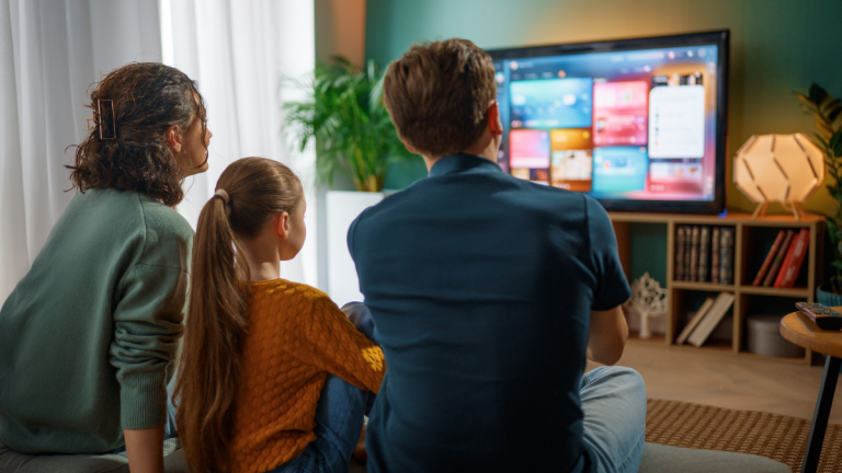 A family watching a group of advertisements on television